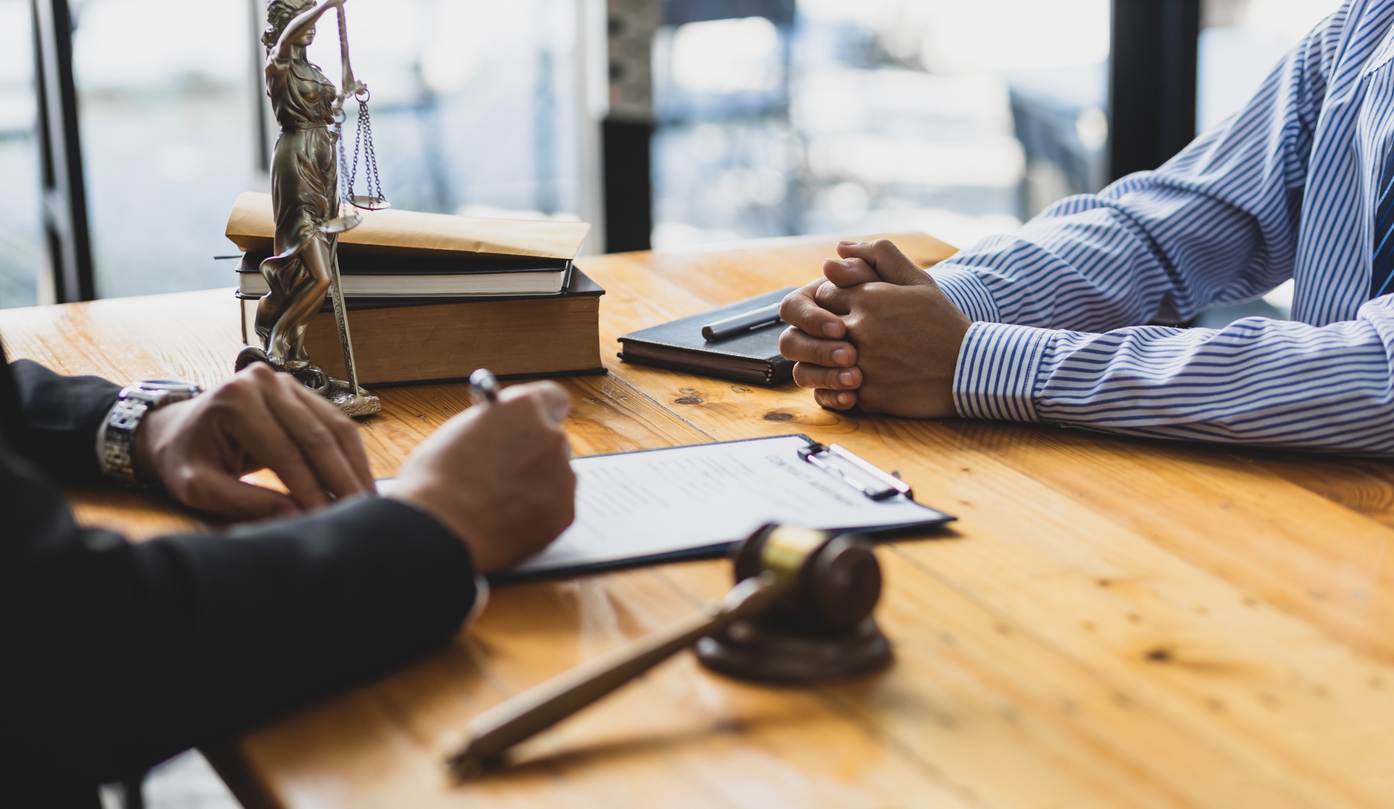 Legal consulting services, legal negotiations, Lawyer are signing legal contract agreement document.