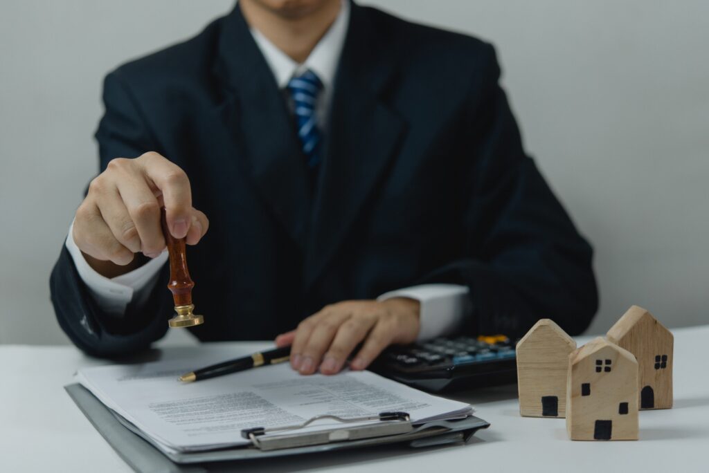 Man approving documents finance, banking, investments, marketing on desk. contract law, or rubber st